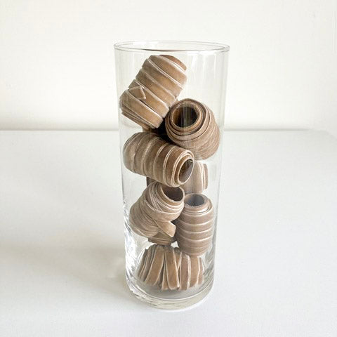 Glass Cylinder Vase holding ribbon